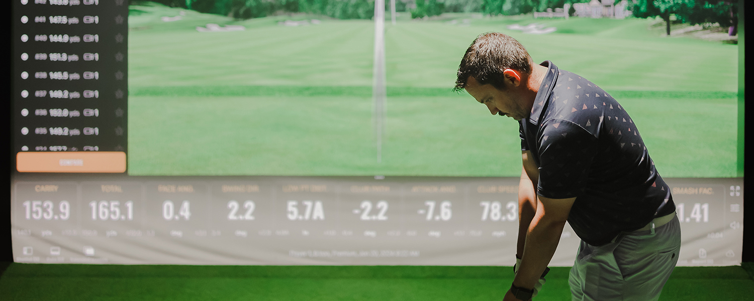 Man teeing off at Transcend Golf using Trackman iO driving range